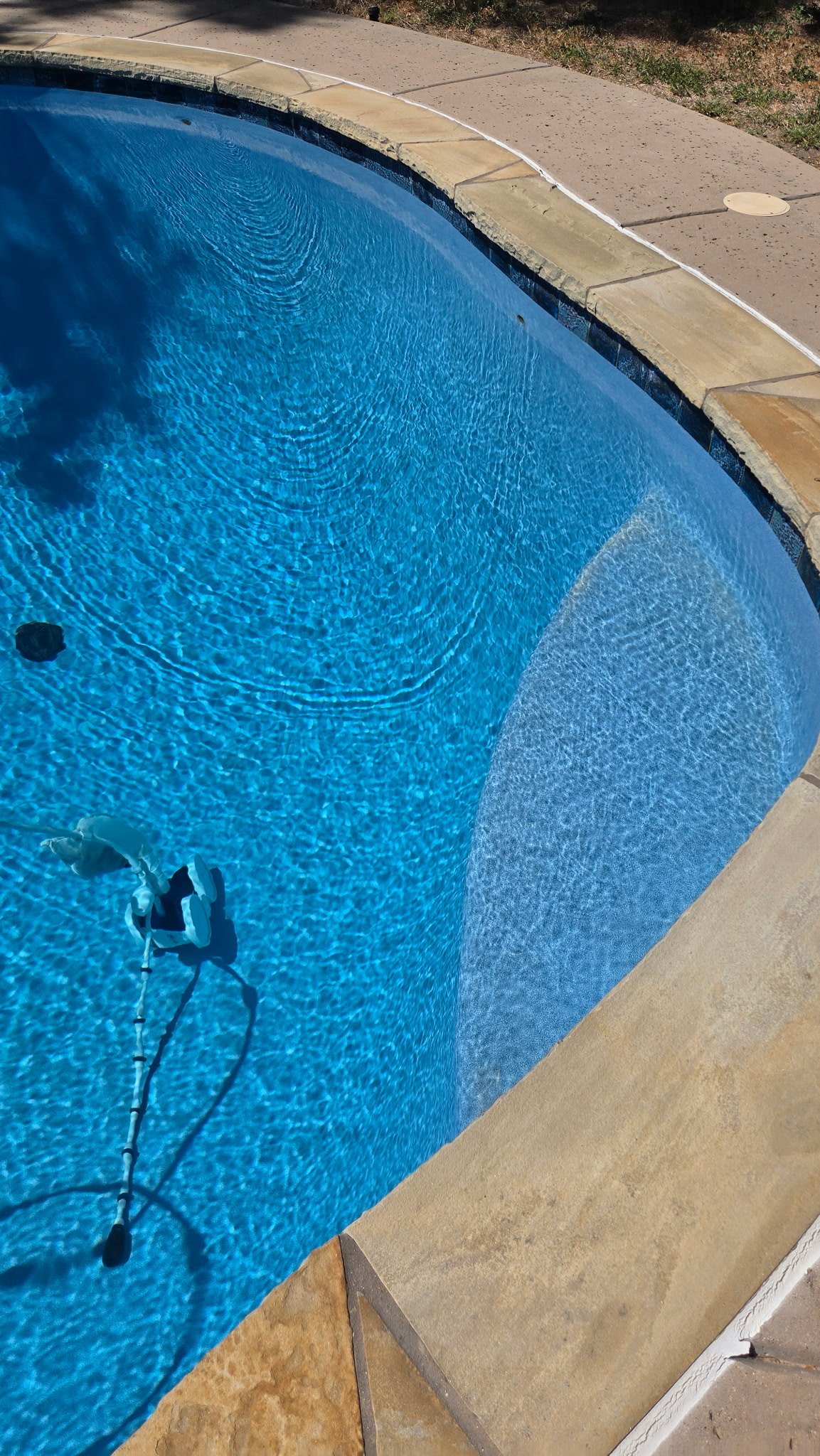 Swimming pool showing localized EcoFinish wear on a step