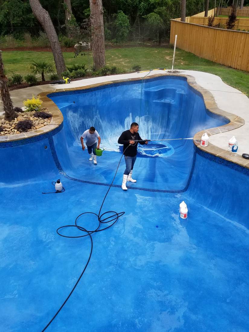 Acid-wash cleanup in progress on an older plaster pool
