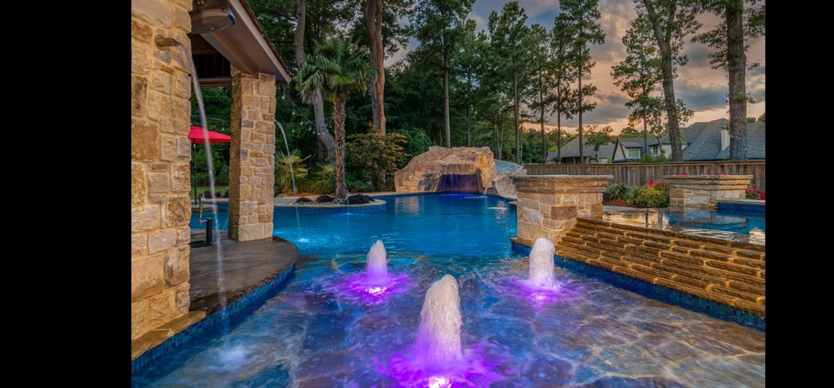 Quartz plaster pool with grotto waterfall and LED deck jets