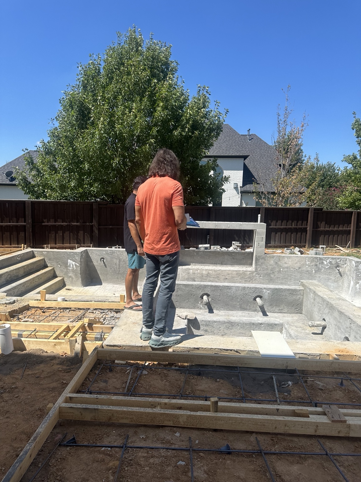 Matt Phillips reviewing a swimming pool during new construction