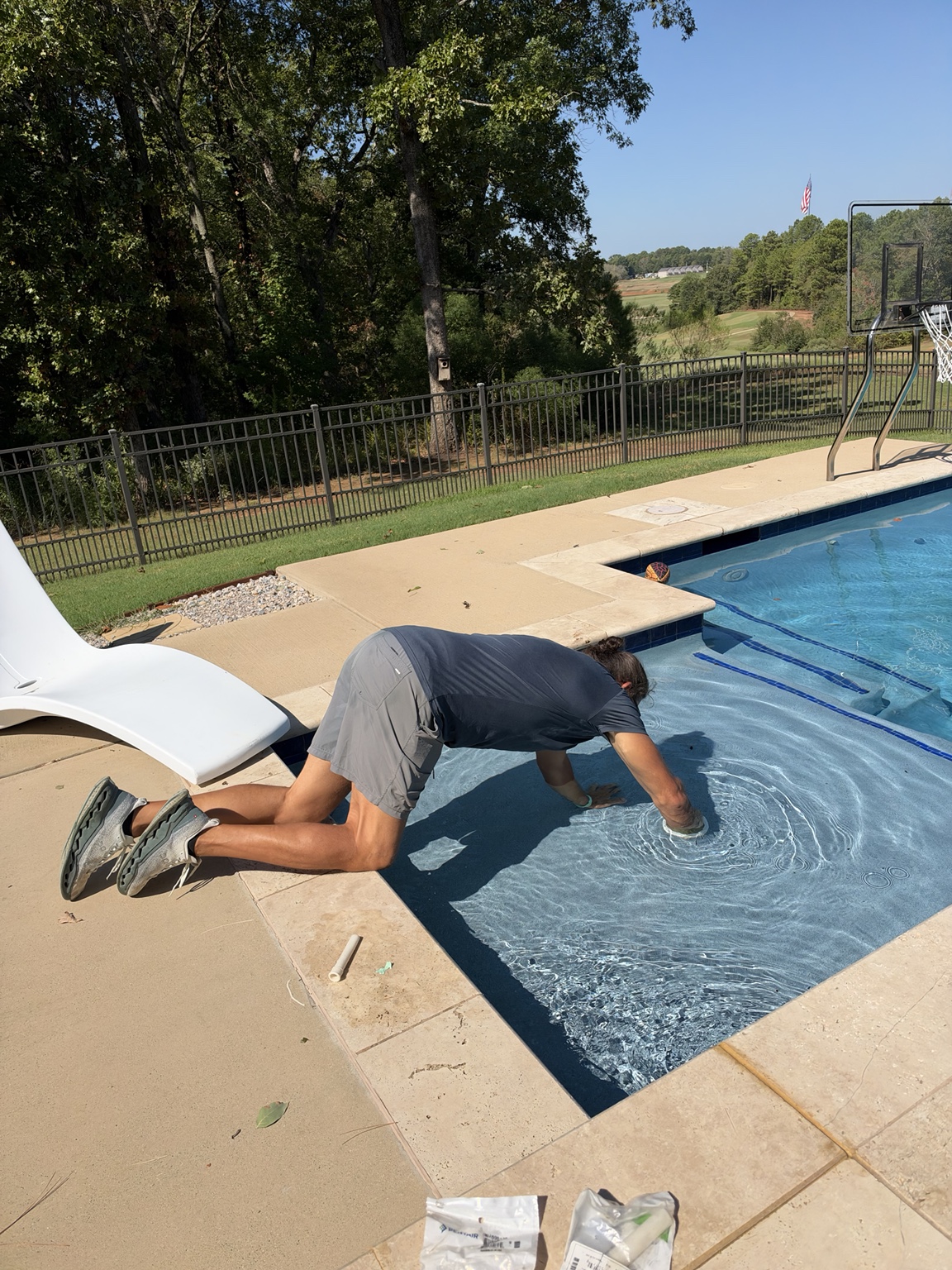 Matt Phillips physically examining the interior surface of a swimming pool