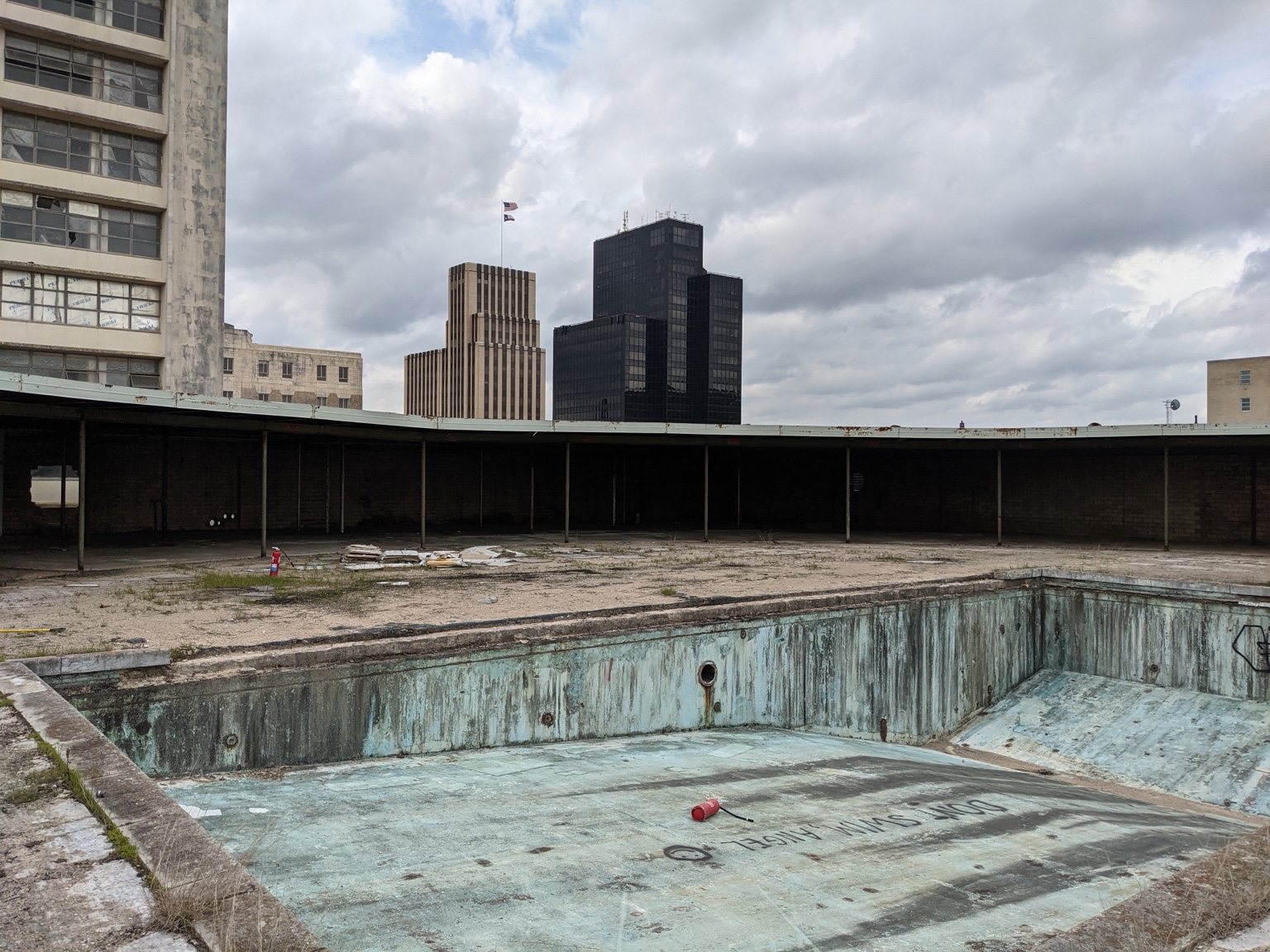 Abandoned rooftop swimming pool in downtown Tyler Texas needing structural rehabilitation
